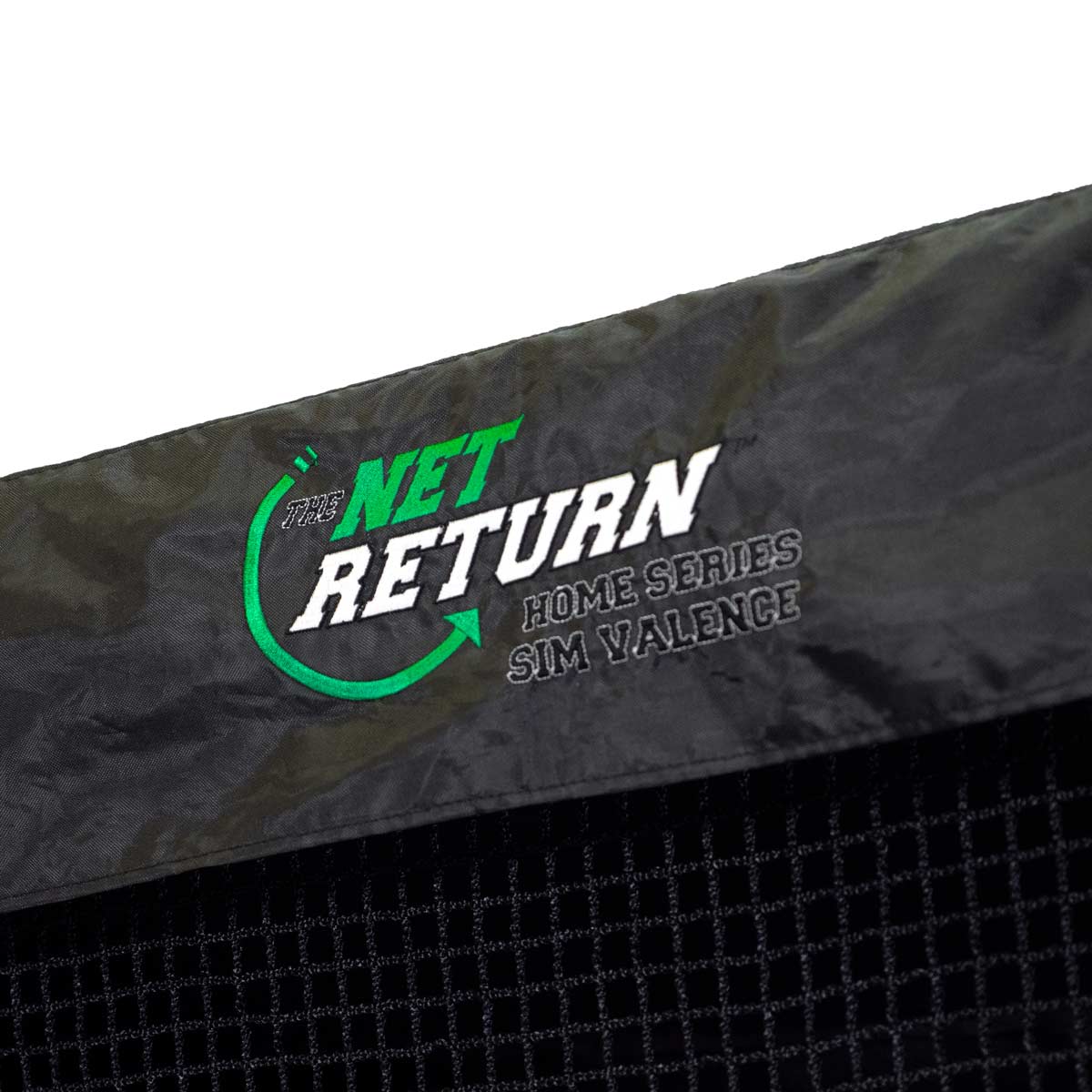 Close-up of the "The Net Return" logo and text on a fabric surface. The logo features green and white colors with additional text "Home Series" and "Sim Valence.