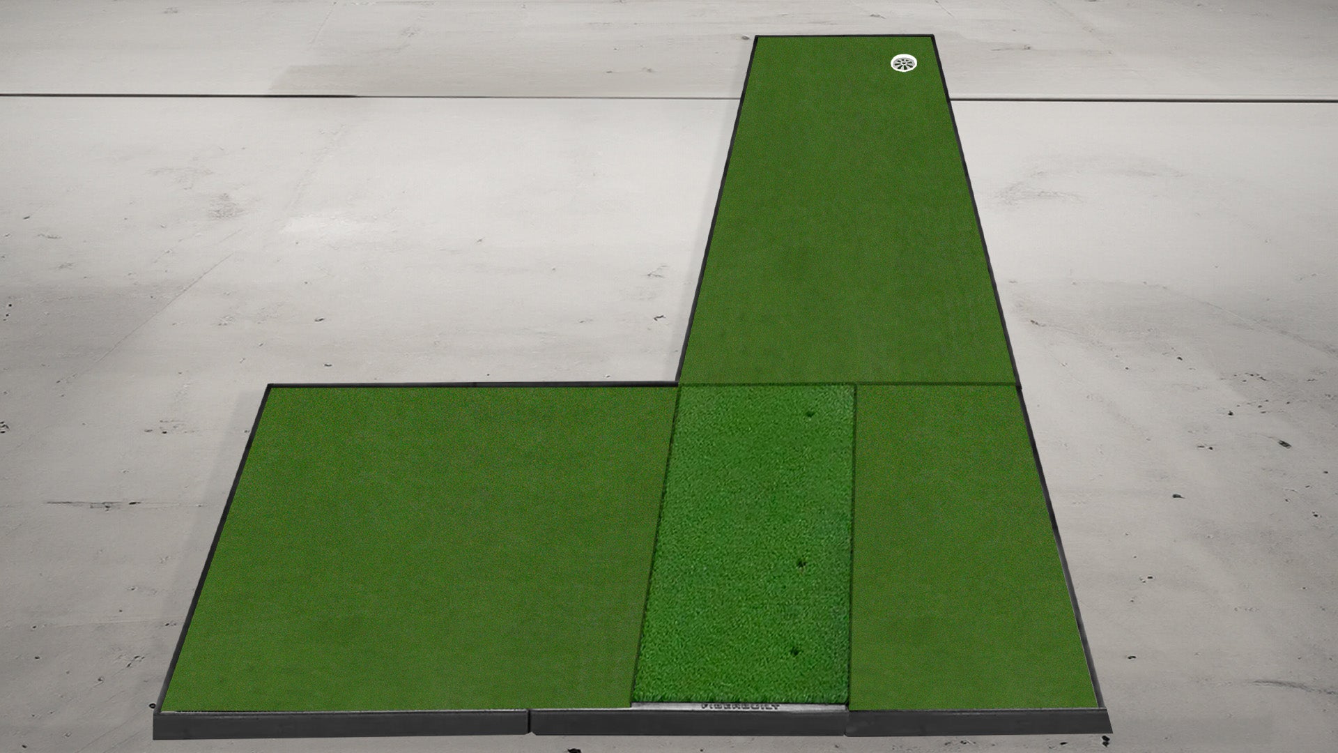 Rectangular golf practice mat with a raised tee section on a concrete floor.